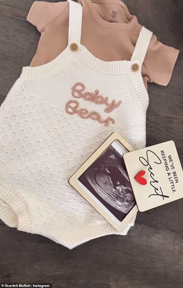 She shared a snap of her scan and an adorable baby grow